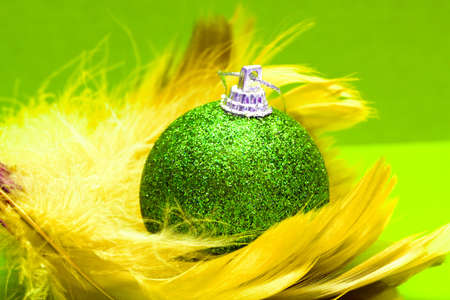Christmas ball on yellow feather の写真素材