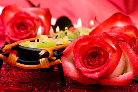 row of green candles with roses の写真素材