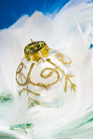Christmas ball on white feather の写真素材