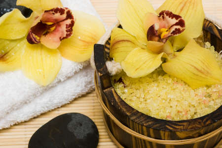 Spa essentials (salt for bath, white towel and orchids) の写真素材