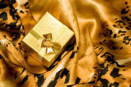golden gift box on silk background の写真素材