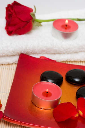 Spa essentials (candle, stones and petals of red rose) の写真素材