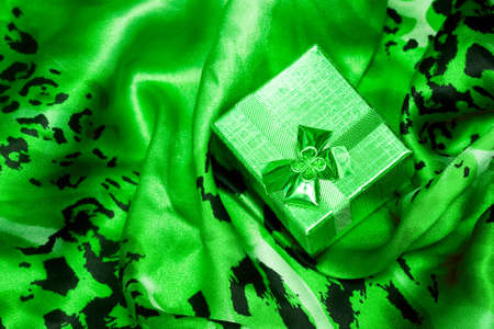green gift box on silk background の写真素材