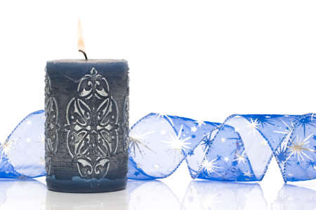 blue burning candle on white background の写真素材