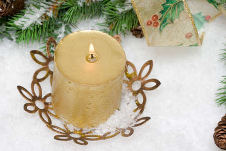 gold festive candle with fur-tree の写真素材