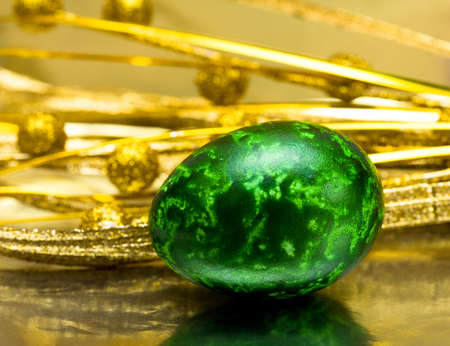 Easter egg with golden leaves の写真素材