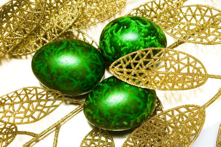 Easter egg with golden leaves の写真素材