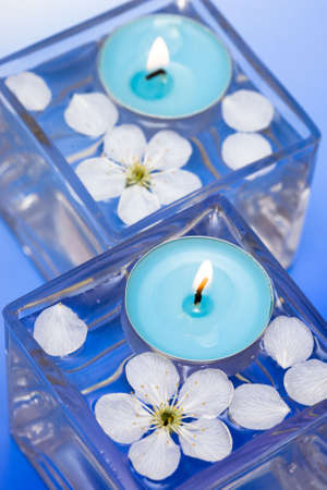 Candle with spring flowers in waterの写真素材