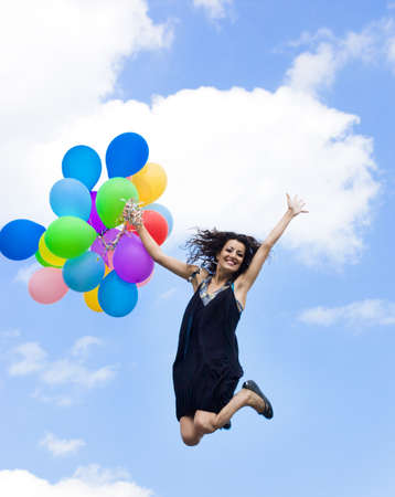 Happy woman with colorful balloons の写真素材