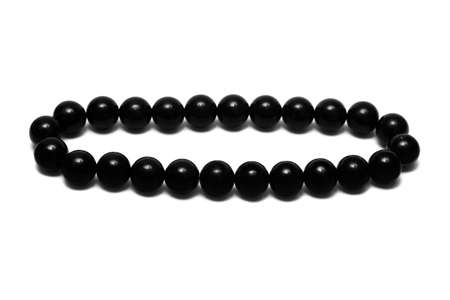 Black beads isolated on white background の写真素材