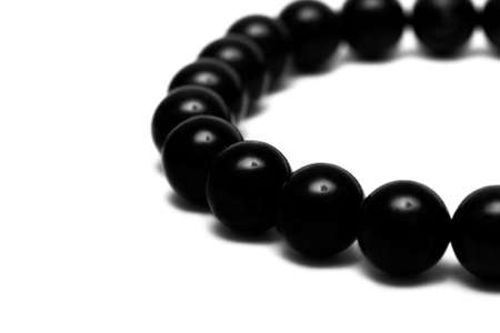 Black beads isolated on white background の写真素材