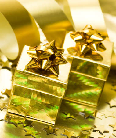 golden gift boxes with ribbon の写真素材