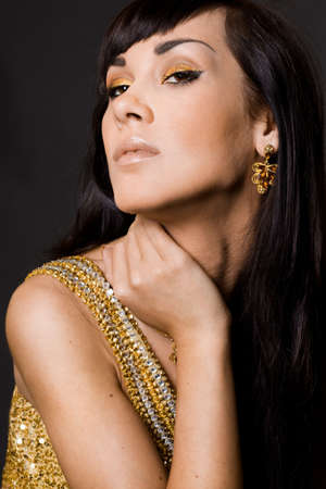 Sexy fashionable woman in golden dress の写真素材