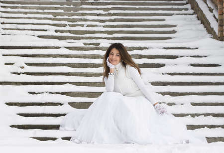 Bride in winter near the stairの写真素材
