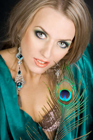 fashionable woman with peacock featherの写真素材