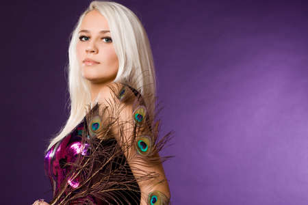 Sexy fashionable woman with peacock feathersの写真素材