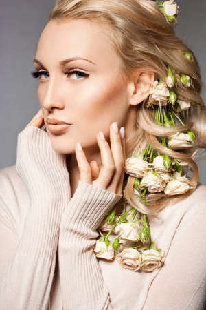 elegant fashionable woman with flowersの写真素材