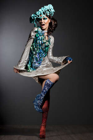 fashionable woman with art visage and hatの写真素材