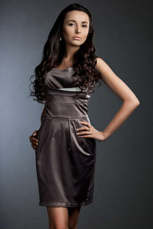 beautiful fashionable woman on grey backgroundの写真素材