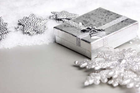 gift box in snow with snowflakeの写真素材