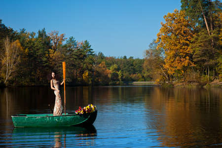 woman on a boat in the autumnの写真素材