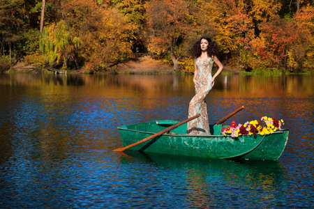 woman on a boat in the autumnの写真素材