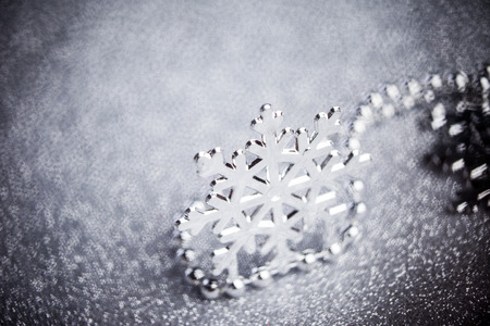 silver snowflake on shiny backgroundの写真素材