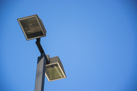 lighting at parking place with blue sky in background.