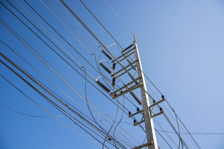 electric pole power lines and wires with blue sky.