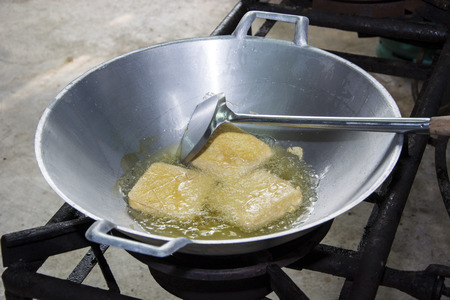 fried tofu in a pan with the boiling oil.の写真素材