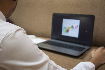 Young man working with laptop. Business man working at home with laptop.の写真素材