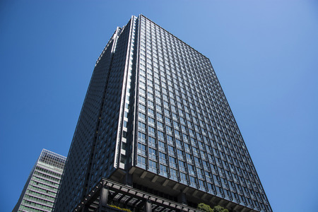 TOKYO, JAPAN -  MARCH 24, 2017: Modern office building with facade of glass.