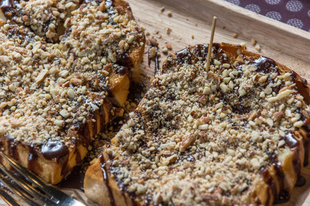 Toast topped with chocolate and nuts in dish.の写真素材