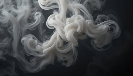 Delicate white smoke curls and swirls gracefully in a dark setting, creating an otherworldly atmosphere.の素材