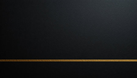Dark textured surface features a thin gold line, creating a sleek and modern backdrop suitable for various designs.の素材
