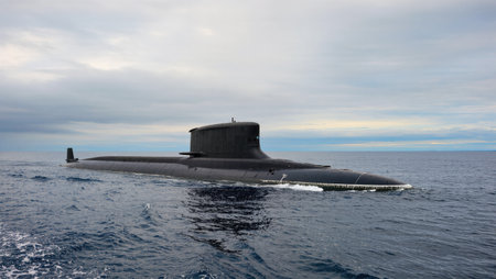 A sleek submarine navigates the open sea amidst a dramatic sky while maintaining a quiet presence.の素材