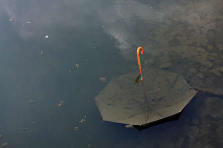 Umbrella thrown out in the river pollution