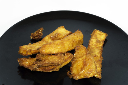 Thai snack, Fried potatoes on black plateの写真素材