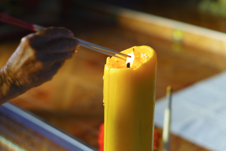 Old people is lighting incense stickの写真素材