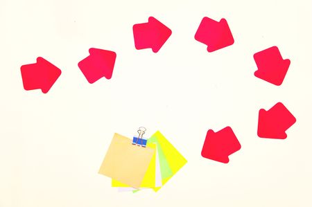 Arrows indexes with colour pieces of paper on white backgroundの写真素材