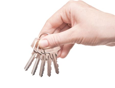 metal keys in woman hand isolated on the white background の写真素材