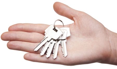 metal keys in woman hand isolated on the white background の写真素材