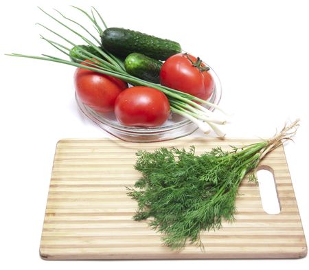 Tomatoes and cucumbers on the cutting boardの写真素材