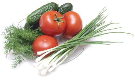 tomatoes and cucumbers on the cutting boardの写真素材