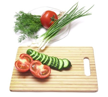 tomatoes and cucumbers on the cutting boardの写真素材