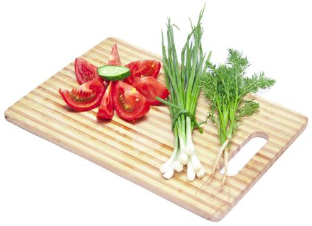 tomatoes and cucumbers on the cutting boardの写真素材