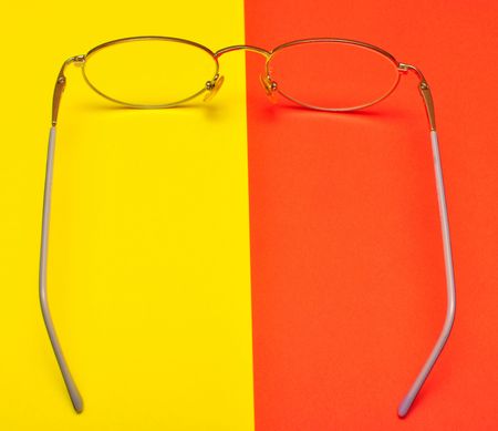 glasses for eyes on yellow and red backgroundの写真素材
