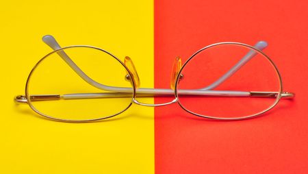 glasses for eyes on yellow and red backgroundの写真素材