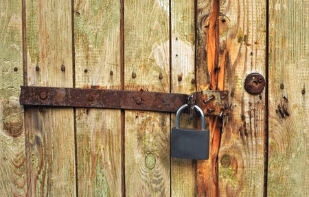 iron bolt on wooden door beaten by the old bent nailsの写真素材
