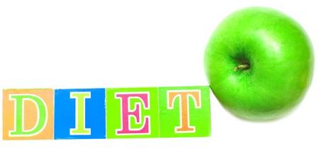 green apple and cubes with letters in front of a white background - dietの写真素材